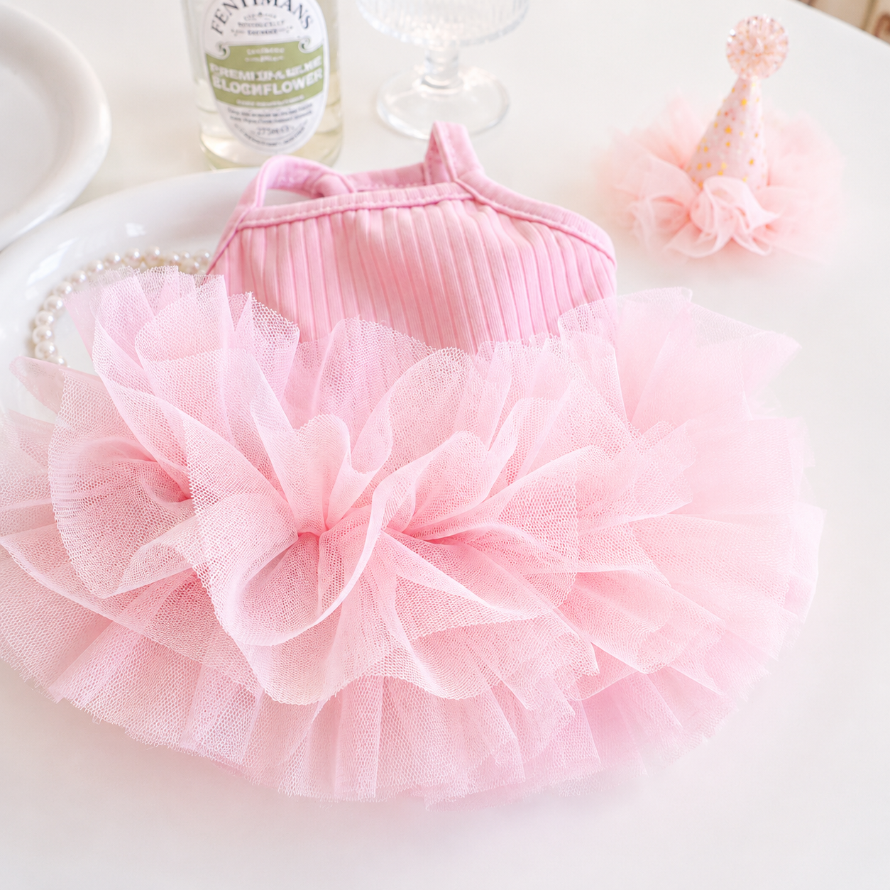 Close-up detail of pink ice silk ribbed dog dress with fluffy layered tulle skirt
