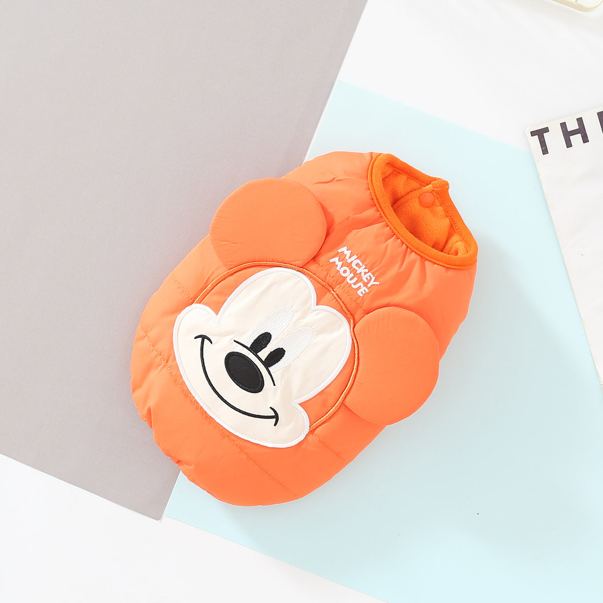 Orange cartoon padded dog vest with raised face and ears