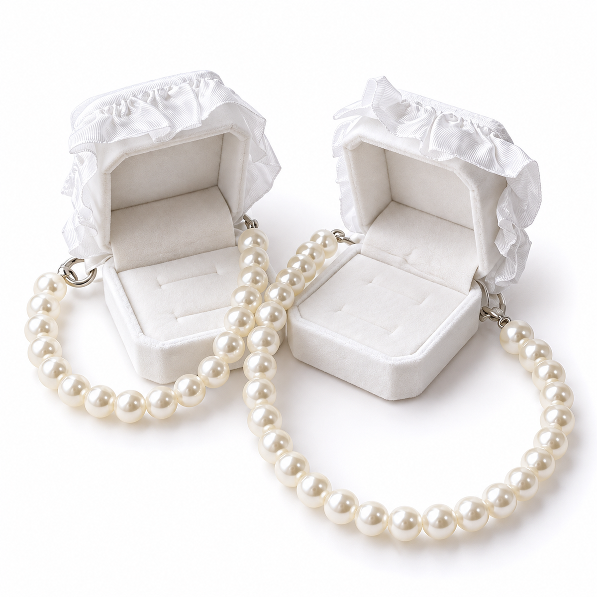 Open white wedding ring boxes attached to pearl-look pet necklaces