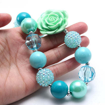 Close view of aqua pet necklace beads and mint rose decoration
