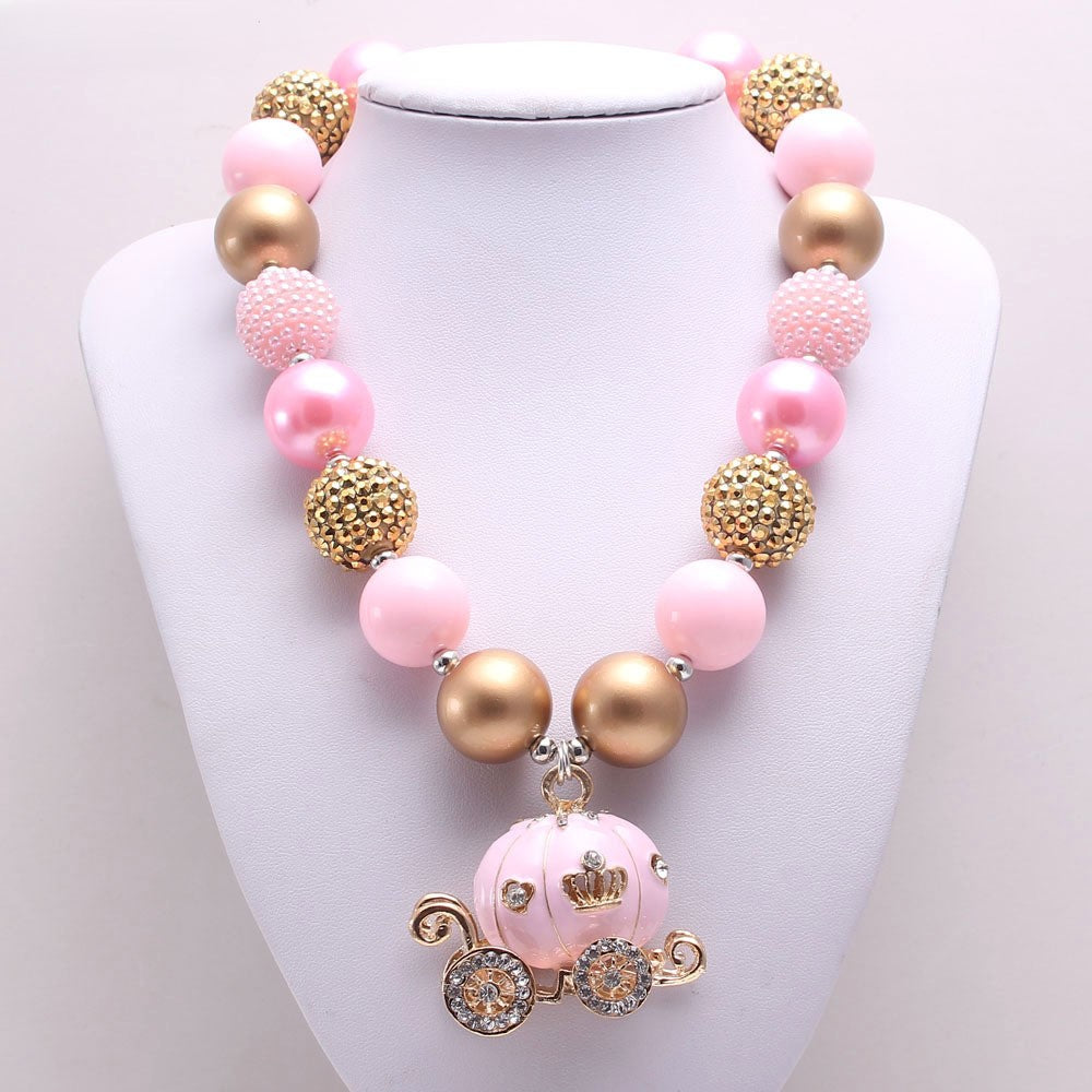 Front view of pink and gold beaded pet necklace with carriage charm