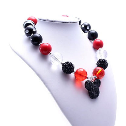 Red and black beaded dog necklace displayed on a white jewelry bust