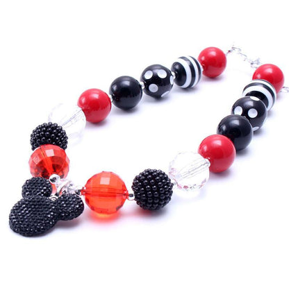 Close angled view of red black clear and striped beaded pet necklace