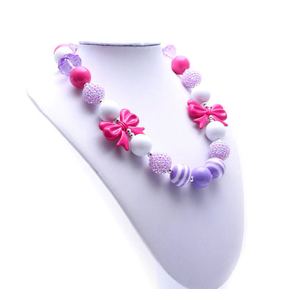 Angled view of pink bow beaded pet necklace on white jewelry bust