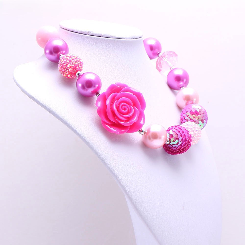 Angled view of pink rose beaded pet necklace displayed on white bust