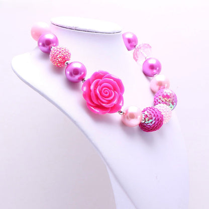 Angled view of pink rose beaded pet necklace displayed on white bust