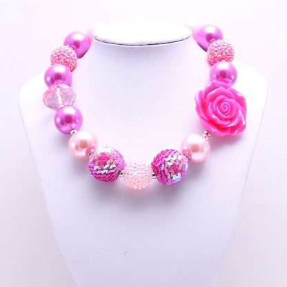 Front view of pink flower dog necklace with pearl-look and sequin beads