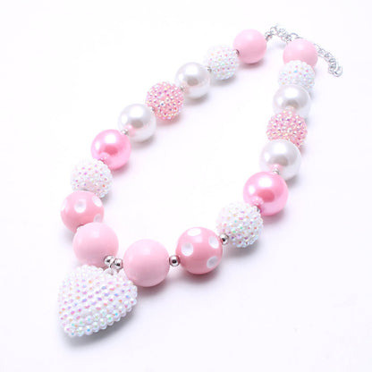 Flat lay of Pink White chunky beaded dog necklace with heart-shaped accent
