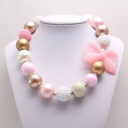 Pink Gold acrylic bead dog necklace with bow displayed on white bust