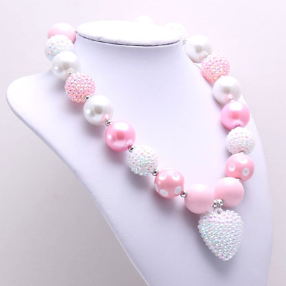 Angled view of Pink White acrylic beaded pet necklace with heart pendant