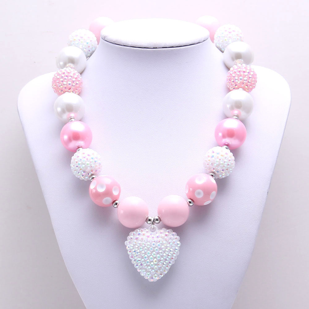 Front view of Pink White 20 mm bead dog necklace and textured heart pendant
