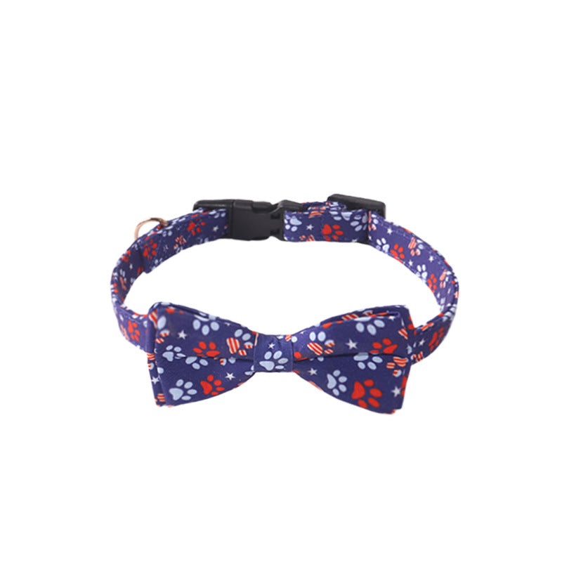 Navy paw print bow tie cat collar with black buckle on white background