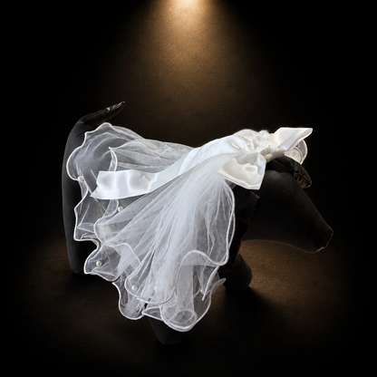 White tulle pet veil hair clip side view on black dog display form with sheer ruffles