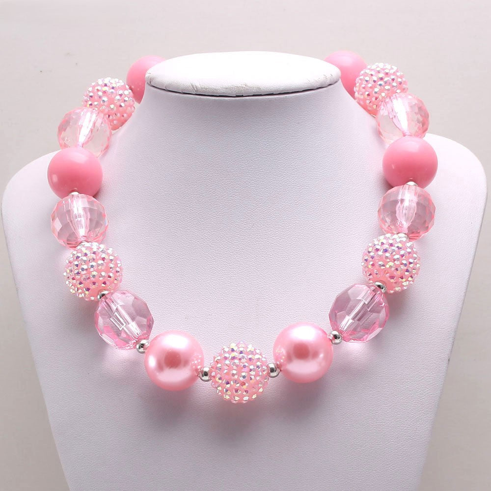 Pink sparkle acrylic beaded dog necklace displayed on a white jewelry bust