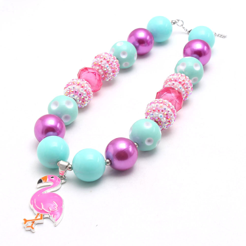 Angled view of mint pink flamingo beaded pet necklace with sparkle accents