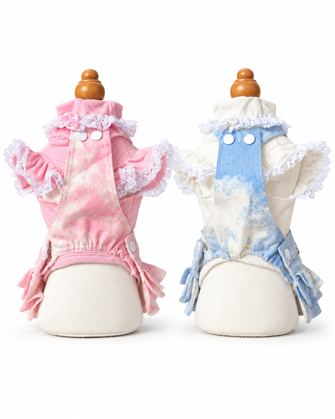 Back view of pink and blue pet outfits with crossed suspender straps and snap closures