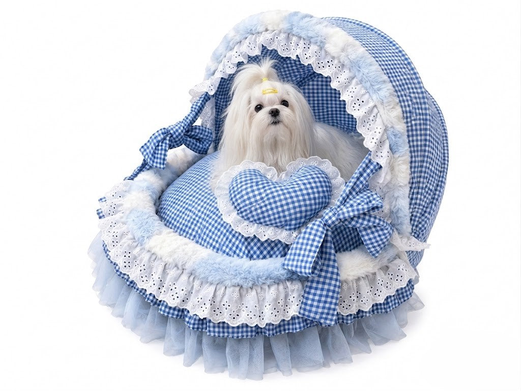 White small dog sitting in blue gingham covered pet bed with lace trim and plush cushion