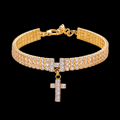 Gold-tone cross pet necklace with clear square accents on black background
