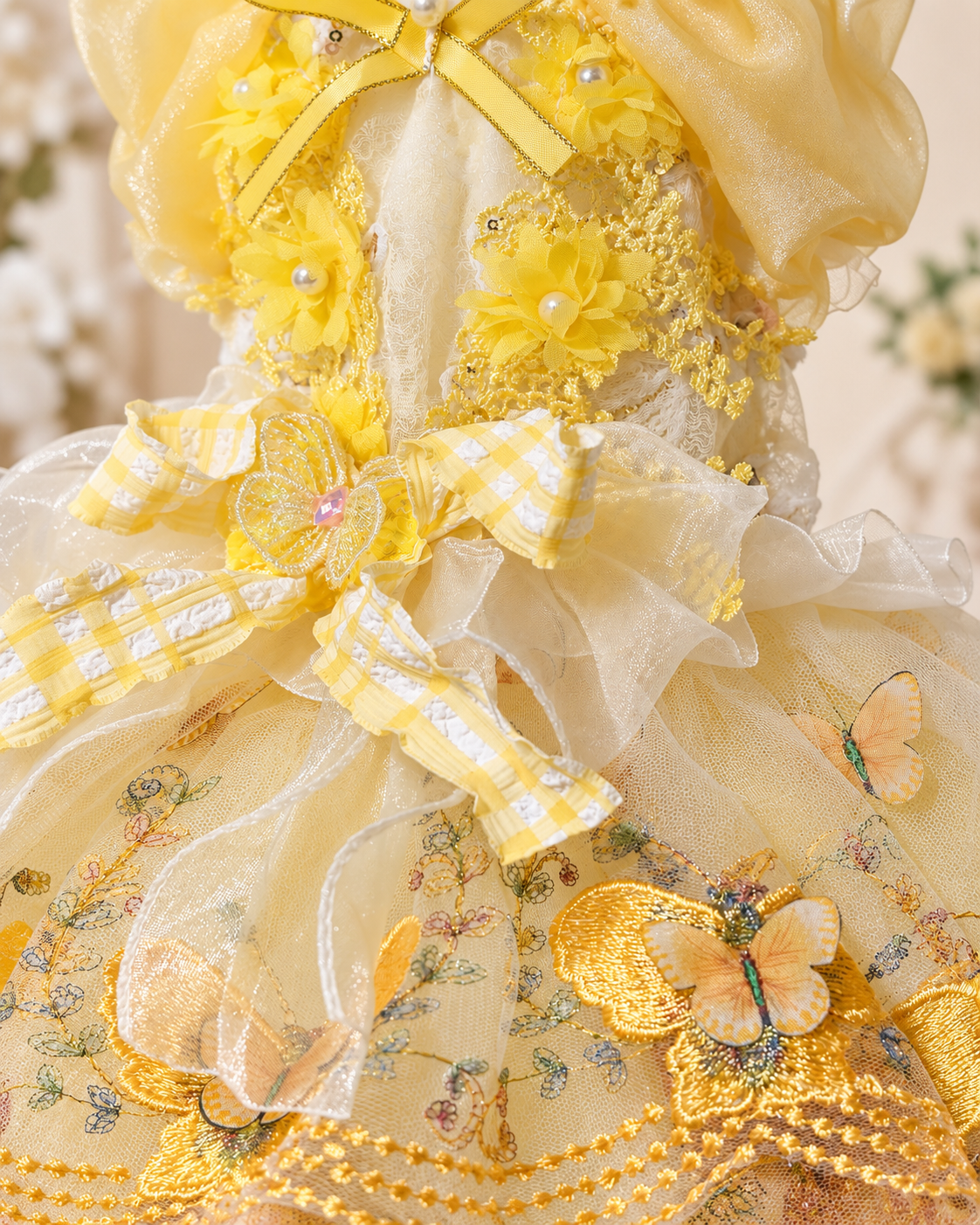 Close-up of yellow pet dress floral lace butterfly appliques and layered tulle