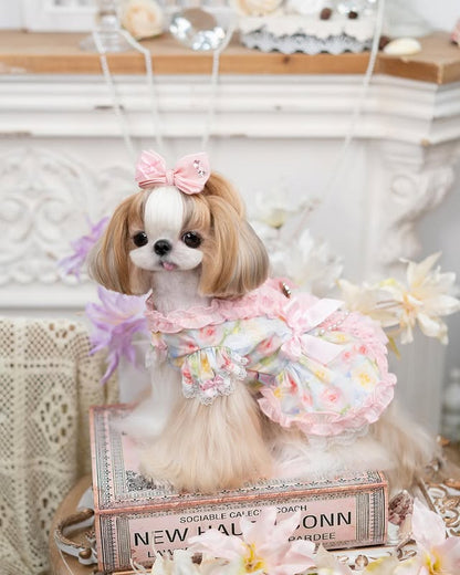Side view of pink floral princess dog dress featuring satin bow, pearl chains, and ruffle details