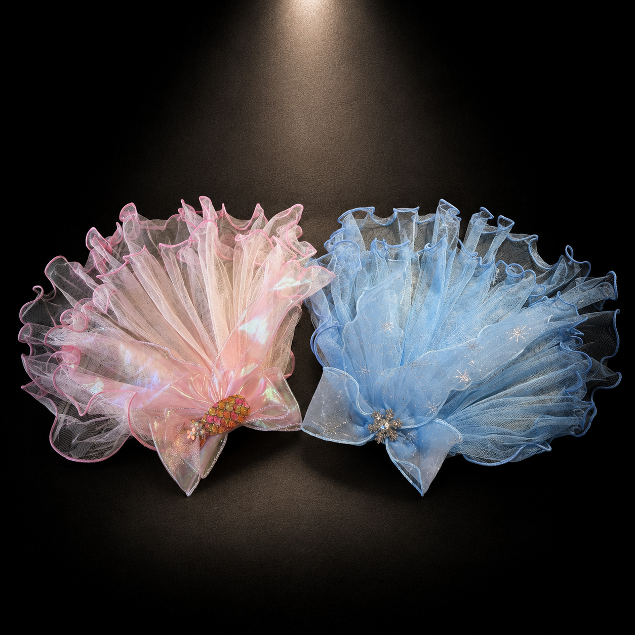 Pink and blue tulle flower pet veil hair clips displayed together on black background