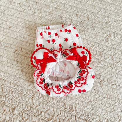 Red cherry-print cotton pet snood shown flat with gathered openings