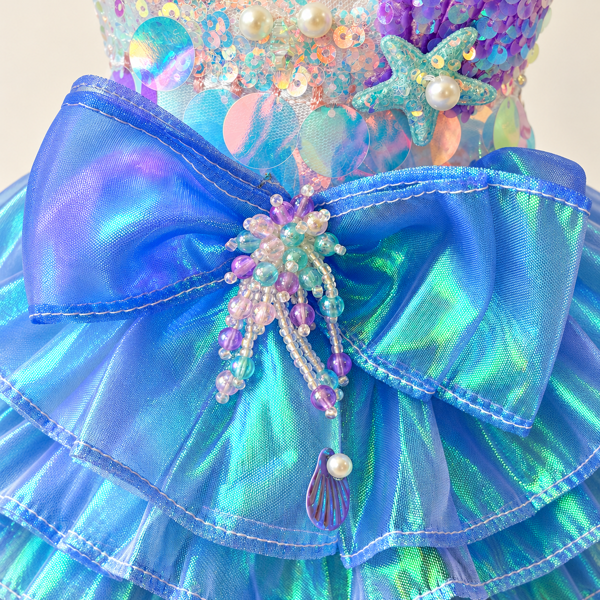 Close view of blue dress bow bead tassel sequins pearls and starfish trim