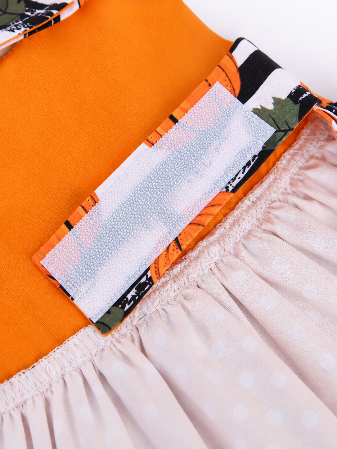 Close-up of hook and loop tab and gathered skirt inside the Halloween pet dress