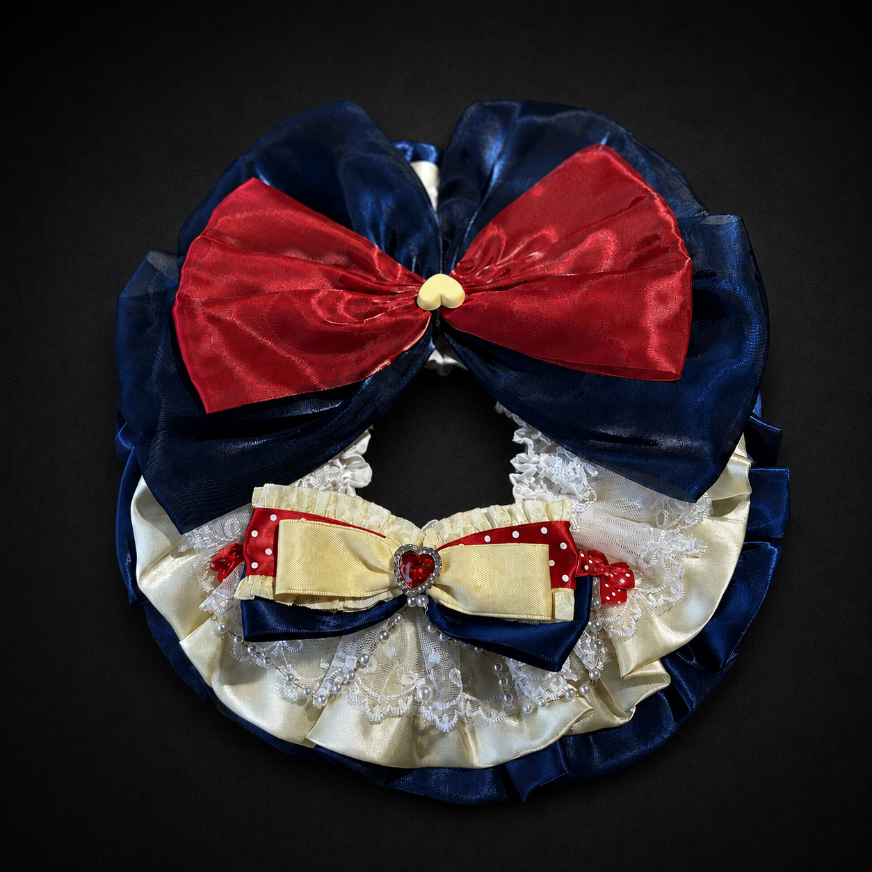 Flat lay detail of storybook pet bib collar with lace pearls red bow and navy ruffles