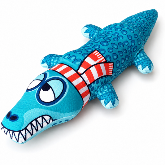 Blue alligator plush dog toy with red striped neck detail and cartoon teeth on white background