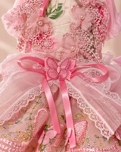 Close-up of pink pet dress butterfly bow floral lace and pearl-style details