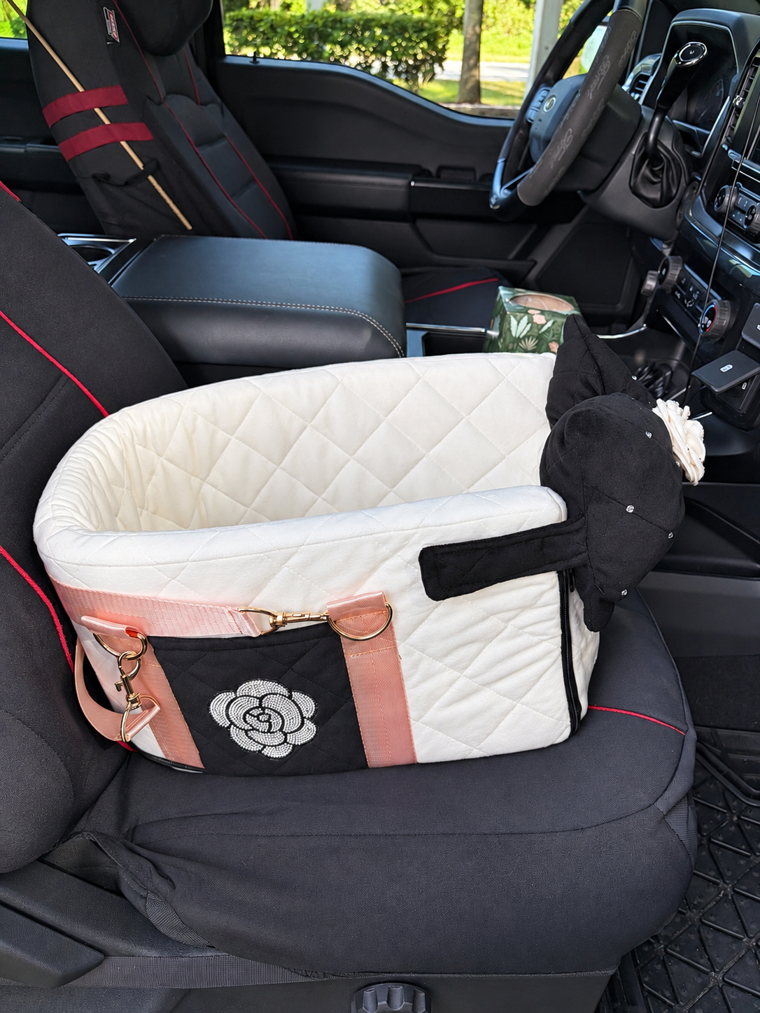 White quilted pet booster seat positioned on a vehicle passenger seat