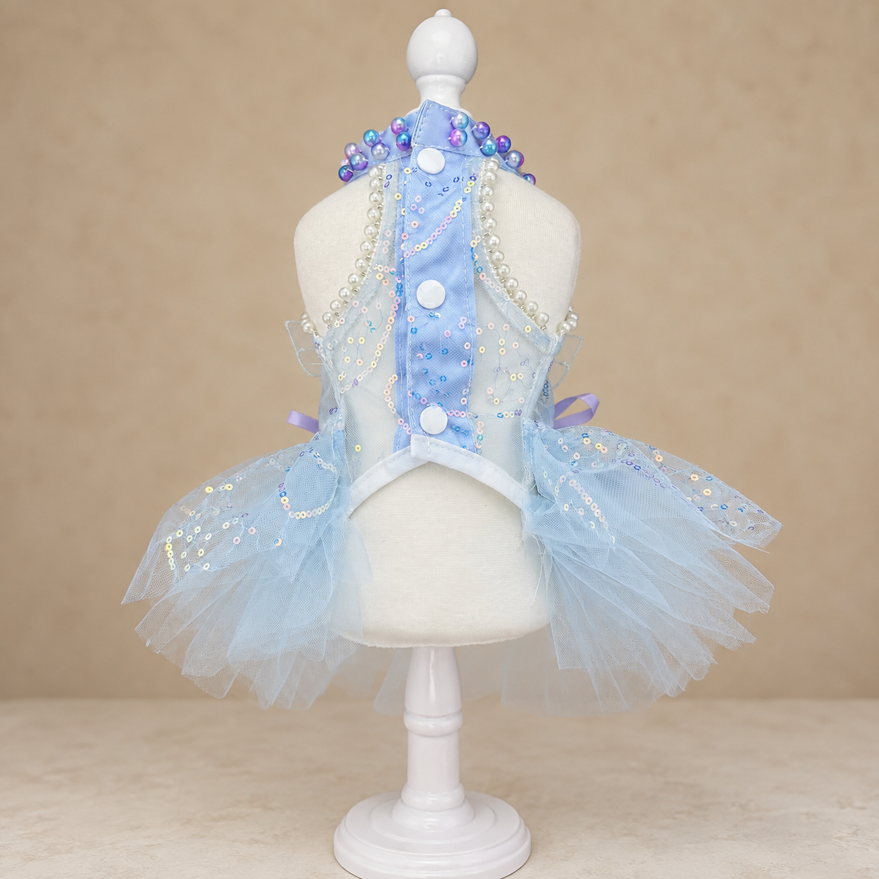 Back view of blue butterfly pet dress with white buttons and tulle skirt