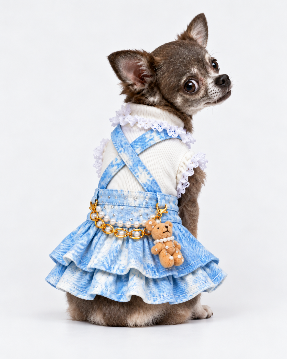 Small dog modeling blue tie-dye denim suspender skirt with white ruffle shirt
