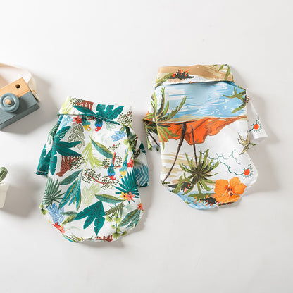 Two tropical Hawaiian dog shirts in green leaf print and orange beach print