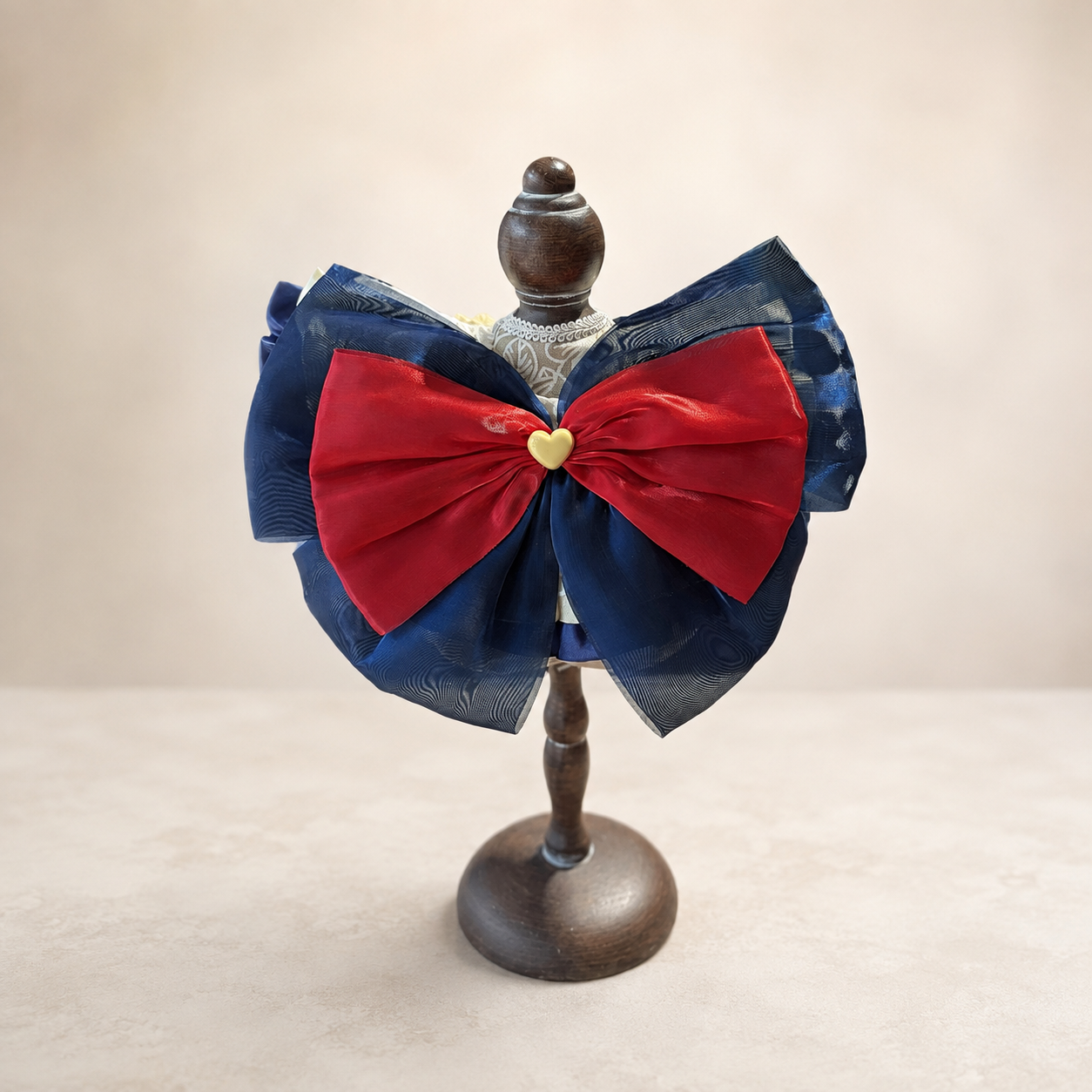 Back view of storybook pet bib collar with navy organza bow and red satin bow