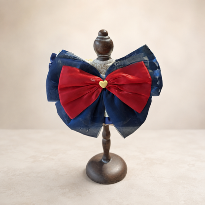 Back view of storybook pet bib collar with navy organza bow and red satin bow