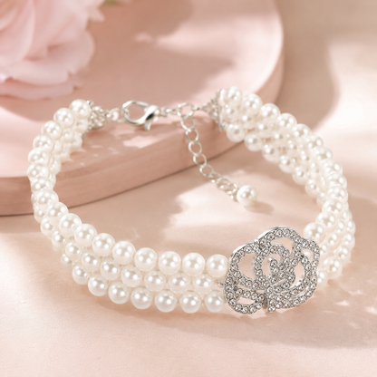 Boutique pet jewelry featuring layered pearls and sparkling rose charm