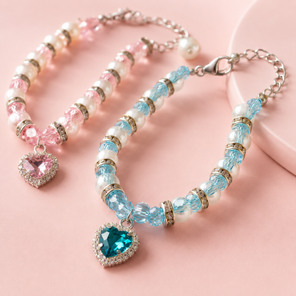 Boutique pet jewelry featuring sparkling heart pendants in pink and blue