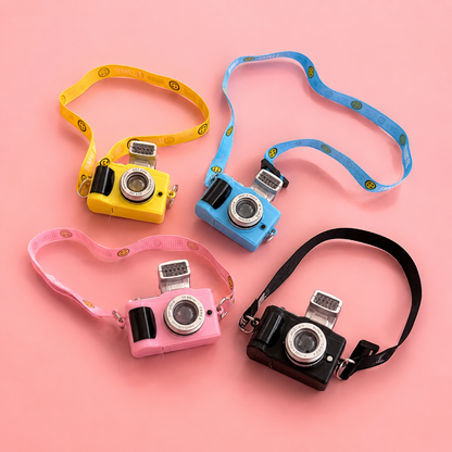 Maltese dog wearing pink camera pendant necklace