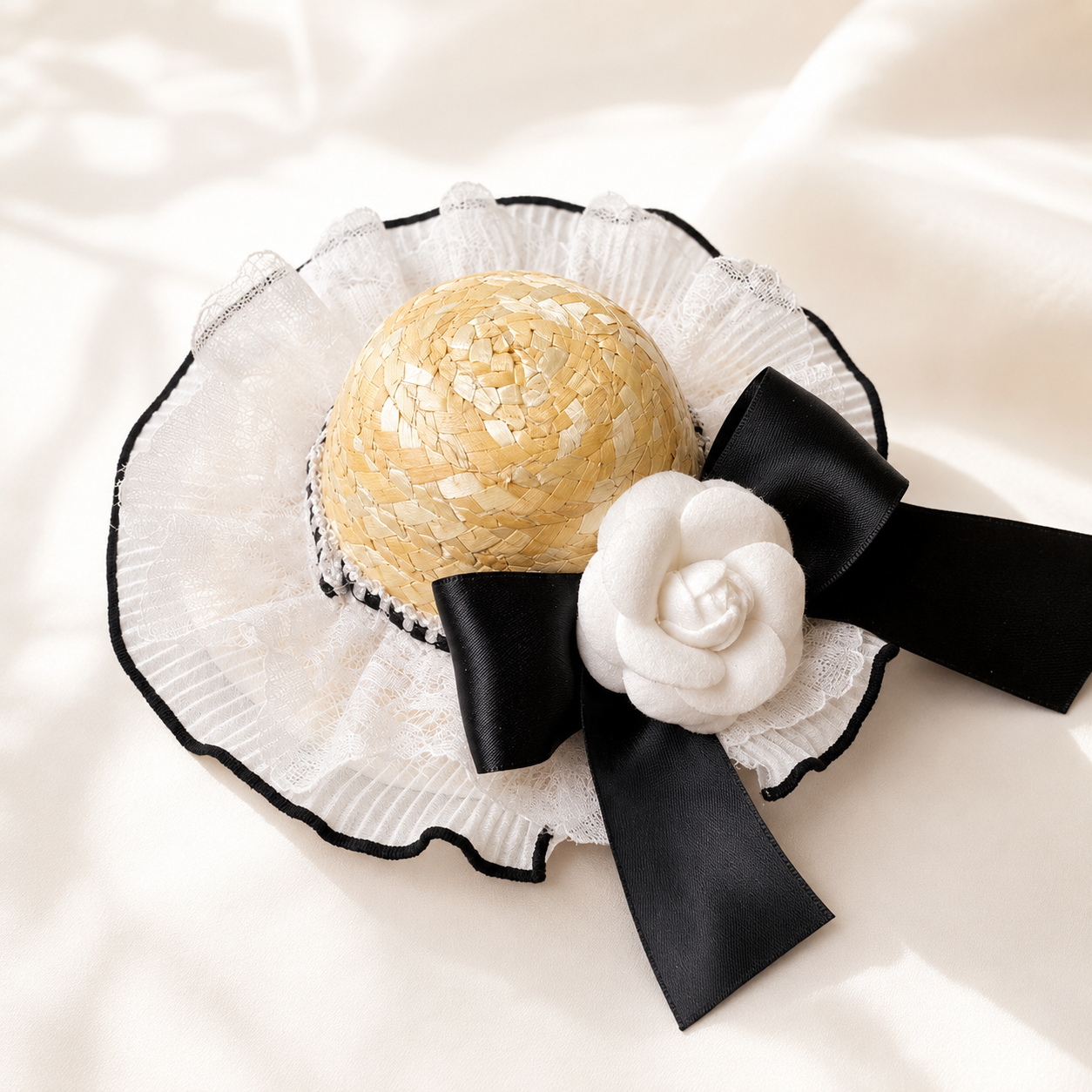 Elegant lace straw pet hat with black satin bow and camellia flower