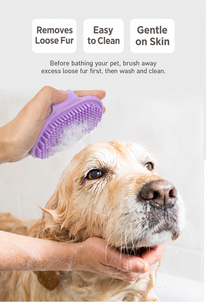 Purple palm-grip bath brush lathering a wet dog coat
