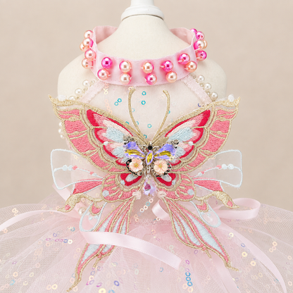 Close-up of pink butterfly pet dress with embroidered butterfly and bead details