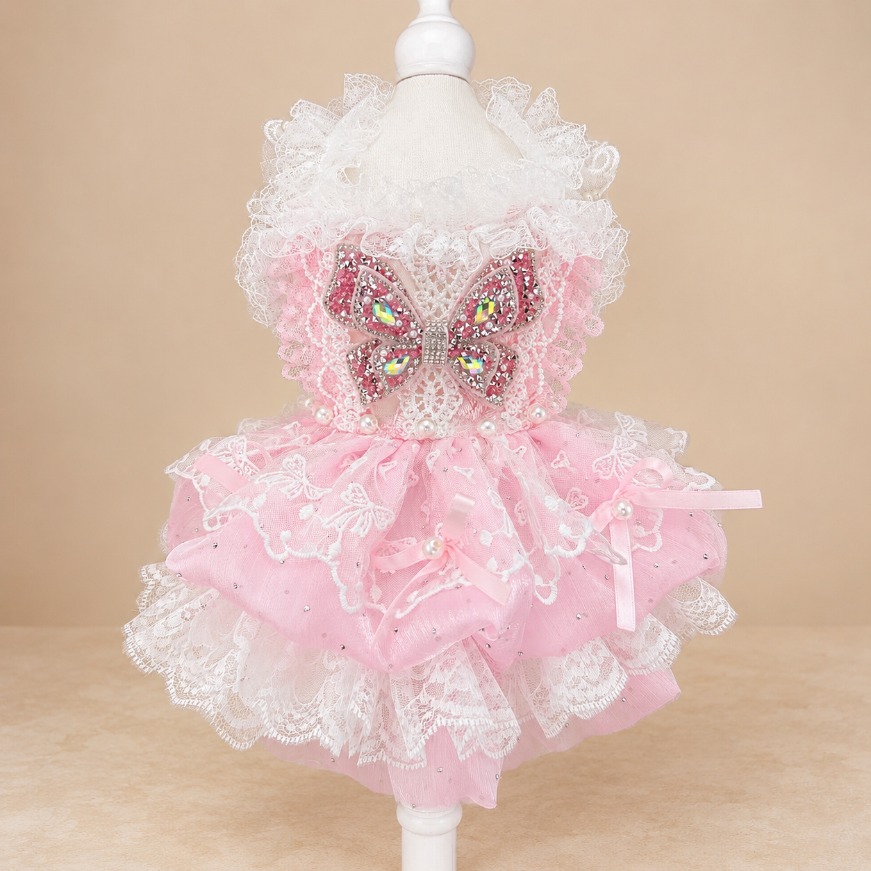Close front view of pink pet dress with lace skirt and butterfly bow detail