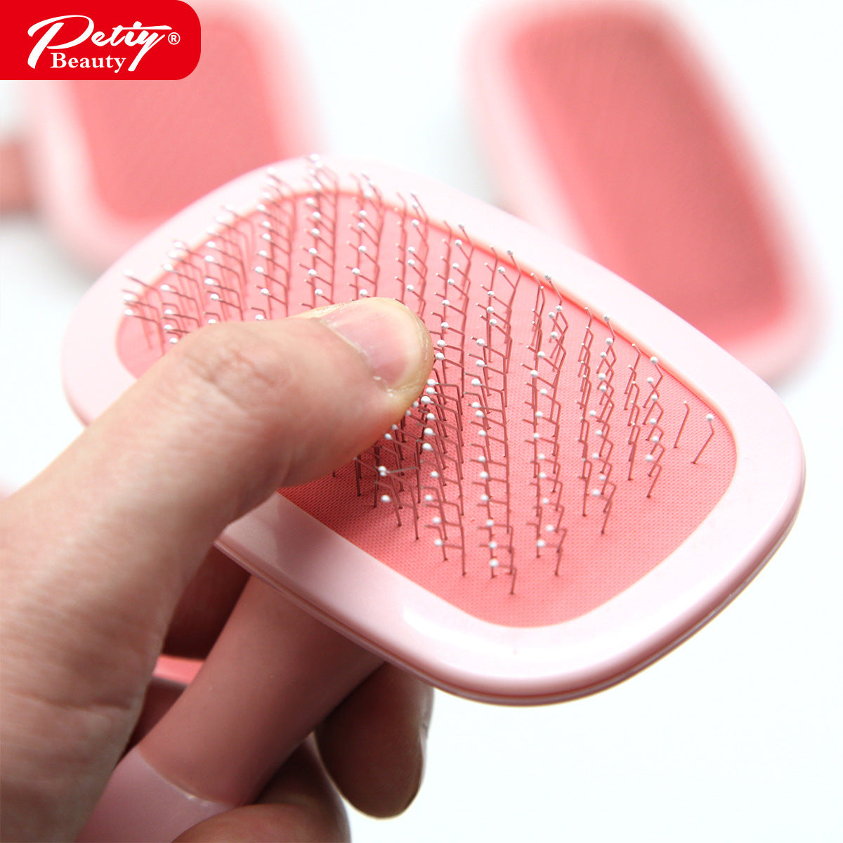 Close-up of flexible Ball Tip pins on pink pet brush cushion