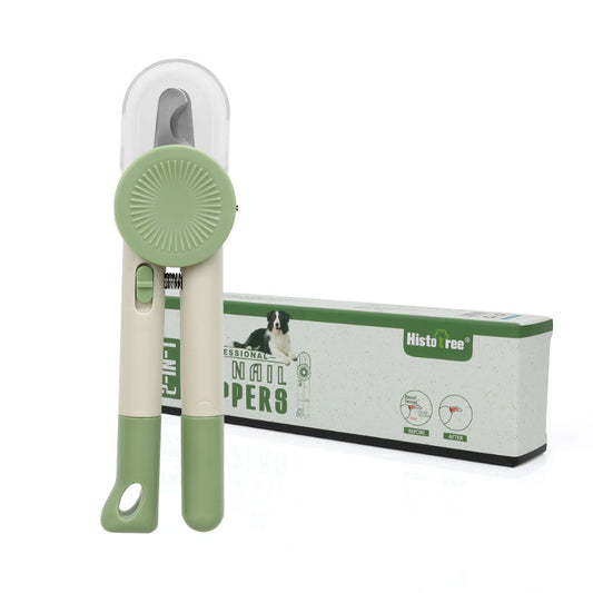 Green and white pet nail clipper standing beside its product box with blade cover visible