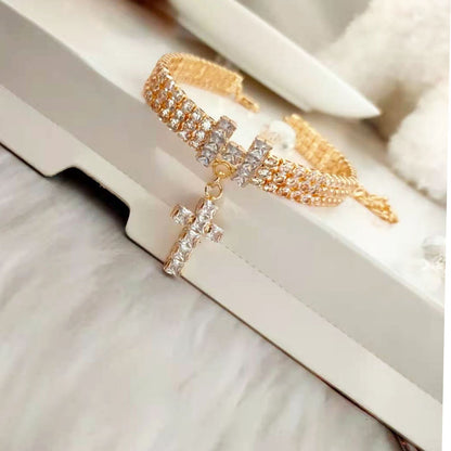 Close view of gold-tone rhinestone dog and cat necklace with dangling cross