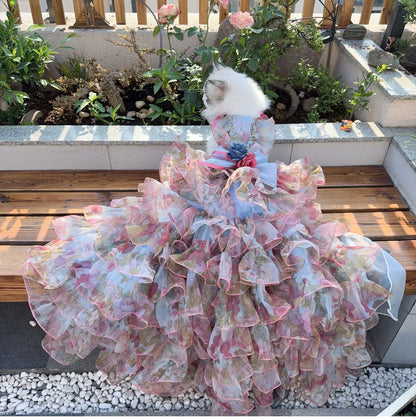 Cat wearing pastel floral pet dress with detachable ruffled gown train