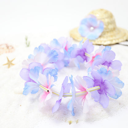 Pastel blue purple and pink flower lei with straw pet hat in background