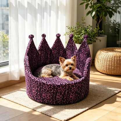 Small dog resting in a purple leopard-print crown pet sofa bed by a window